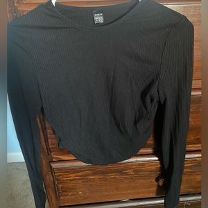 Cropped long sleeve. A little longer in the front than in the back.